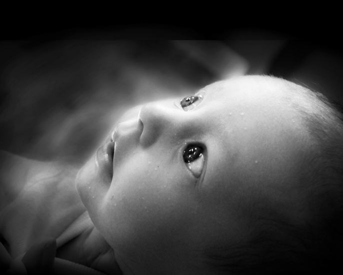 closeup on infant child in black and white