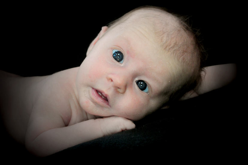 Infant portrait on black background